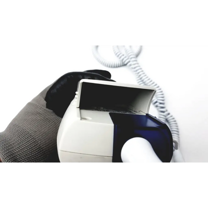 White and blue welch allyn suretemp plus thermometer with coiled cord held in a gloved hand for accurate readings