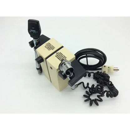 Beige and black medical diagnostic set ophthalmoscope with coiled black cord in welch allyn wall transformer 74710