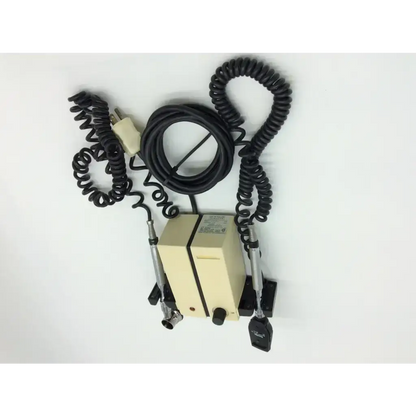 Beige rectangular welch allyn wall transformer with black coiled cables and two metallic probes for diagnostic set ophthalmoscope