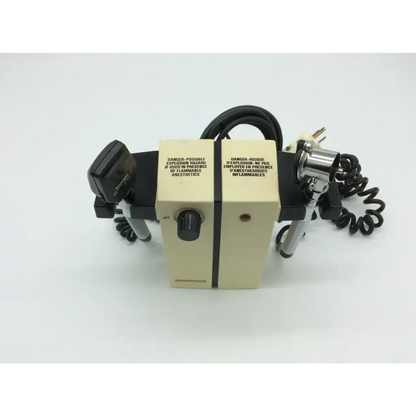 Beige welch allyn wall transformer with black silver components and english french warning labels for diagnostic set ophthalmoscope