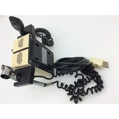 Black and beige welch allyn wall transformer with coiled black cables and cream plug for diagnostic set ophthalmoscope use