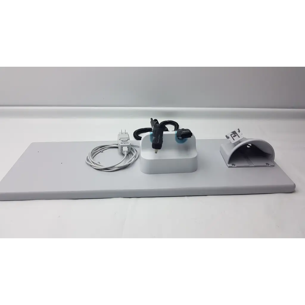Gray plastic mounting plate with integrated power adapter coiled cable and black electronic components for welch allyn wall transformer diagnostic set