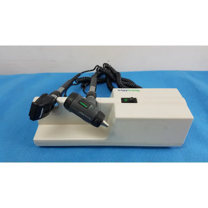 White rectangular welch allyn wall transformer with two black handheld otoscope and ophthalmoscope heads and coiled cords