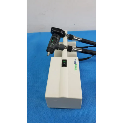 Welch allyn wall transformer with 11720 otoscope heads featuring black and silver articulated arms on white base unit
