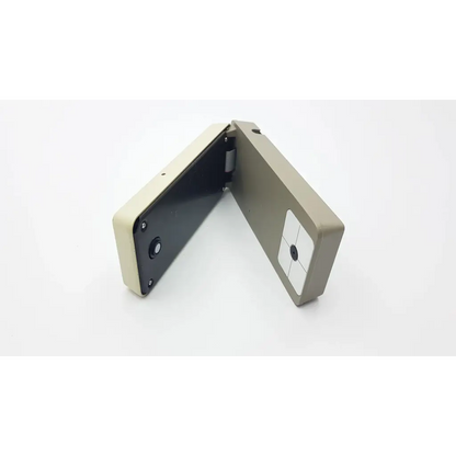 Beige and black foldable x-rite rmi densitometer ac5-377 with circular sensor on front panel for precise color measurement