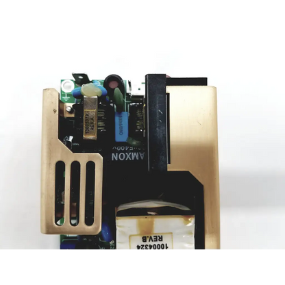 Gold-colored metal casing with black circuit board and amxon label in xp power ecm100us24 ac/dc open frame power supply
