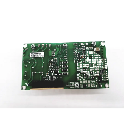 Green rectangular open frame circuit board with silver soldered components and white barcode label for power ecm100us24