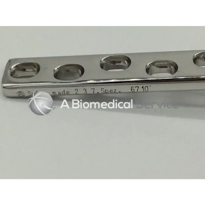 A sleek metallic surgical plate xSynthes 237 Spez 6710 with 16 oval holes ad5-179 for bone fixation