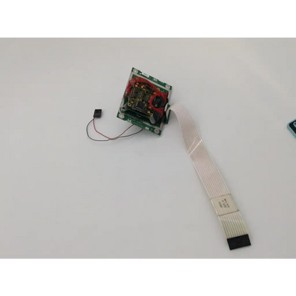 Green circuit board with red wiring and flexible ribbon cable on back of humphrey model 740 camera support visual field analyzer pcba