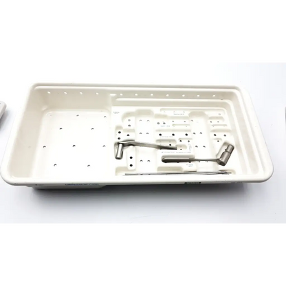 White plastic surgical instrument tray with metallic tools in zimmer compression hip screws kit for orthopedic use