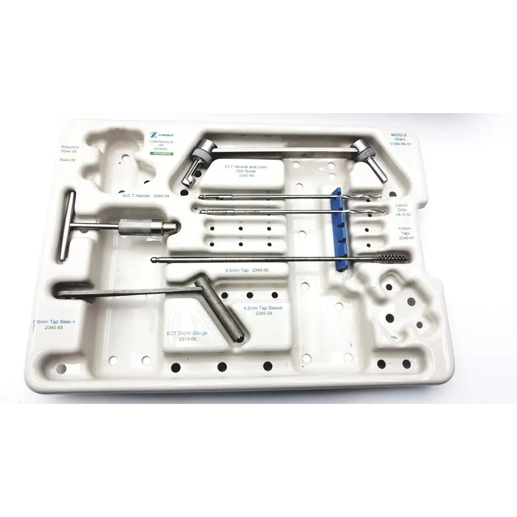 White plastic surgical tray containing stainless steel orthopedic tools from zimmer compression hip screws kit