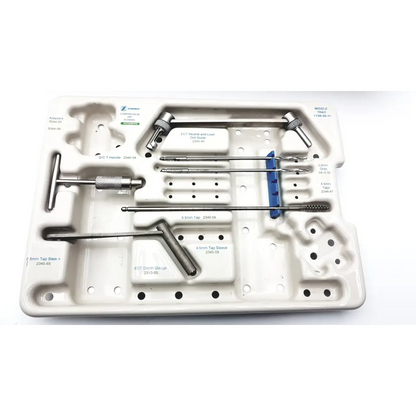 White plastic surgical tray containing stainless steel orthopedic tools from zimmer compression hip screws kit