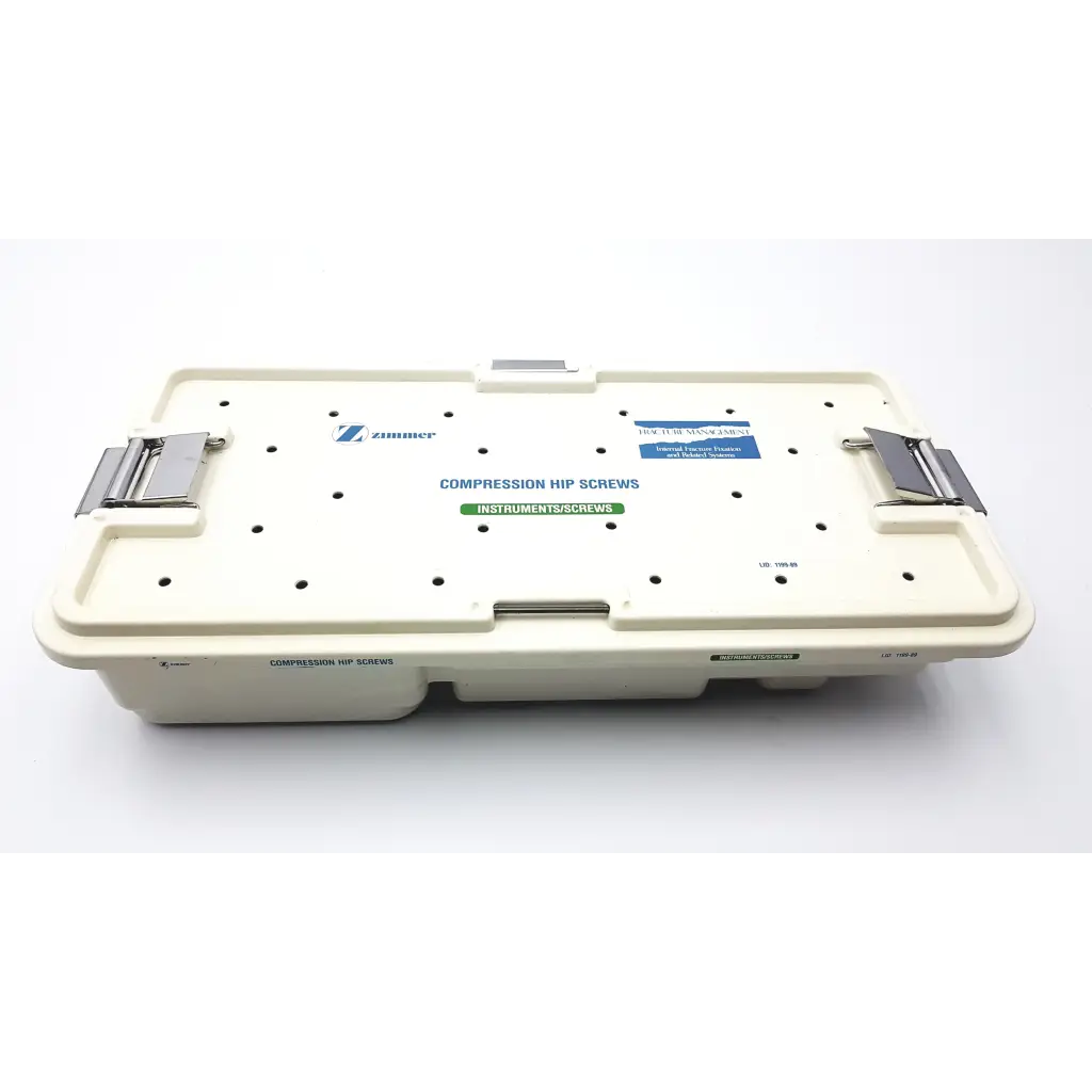 Cream-colored plastic zimmer compression hip screws kit tray with silver metal latches and printed labels