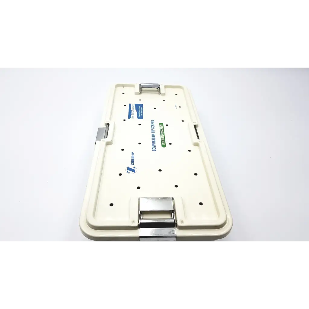Cream-colored plastic zimmer compression hip screws kit with metallic latches for orthopedic hip fixation use