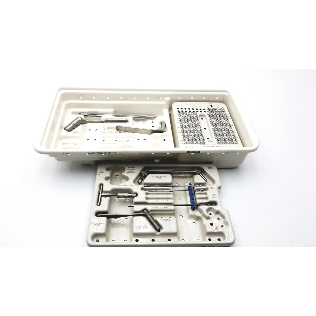 Sterilized zimmer compression hip screws kit with metallic instruments and implants in a beige plastic tray organizer