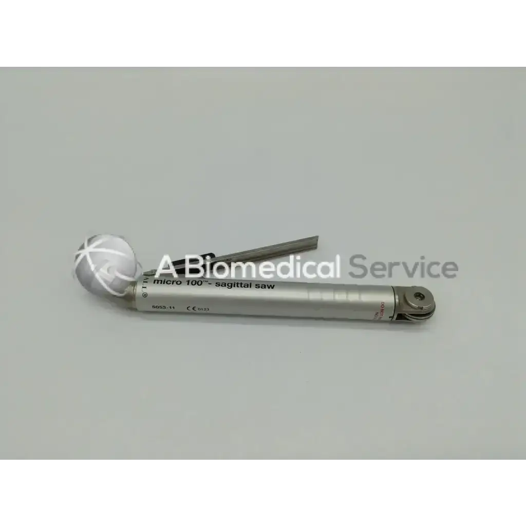 Silver-colored micro 100 sagittal saw with white crosshatch handle and metallic blade in zimmer linvatec hall surgairtome two set