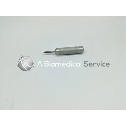 Silver metal punch tool with textured grip and pointed tip from zimmer linvatec hall surgairtome two set