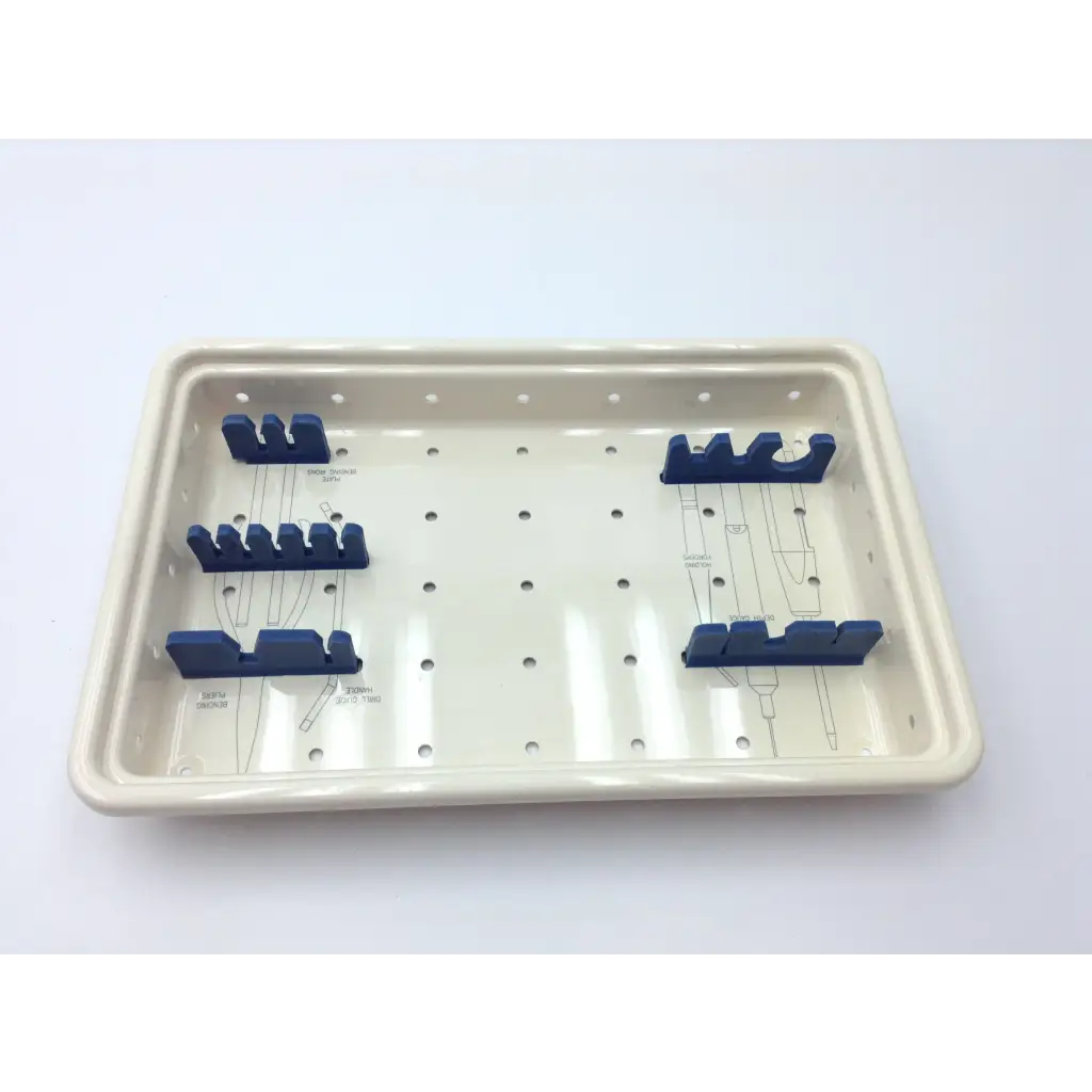 Cream-colored ceramic surgical instrument tray with blue holders in the ascension forefoot set csa-800-01 forefoot set