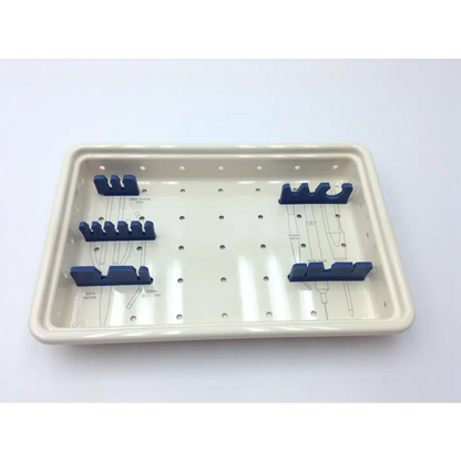 Cream-colored ceramic surgical instrument tray with blue holders in the ascension forefoot set csa-800-01 forefoot set