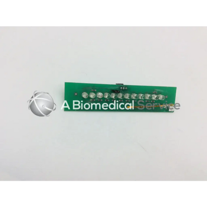 Green rectangular circuit board with ten silver led lights in marquette dash 4000 alarm light assembly