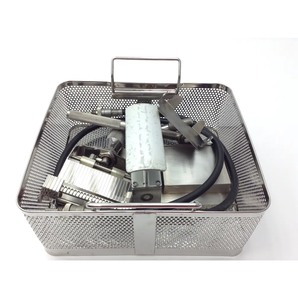 Genesis case sterilization container with stainless steel perforated mesh basket and handle holding Zimmer dental tools