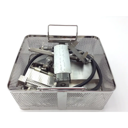 Genesis case sterilization container with stainless steel perforated mesh basket and handle holding Zimmer dental tools