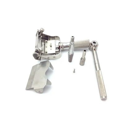 Silver-toned dental handpiece with textured grip and interchangeable attachments in genesis case sterilization container
