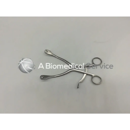 Stainless steel kolbel retractor ring handle with curved serrated jaws for precision surgical clamping