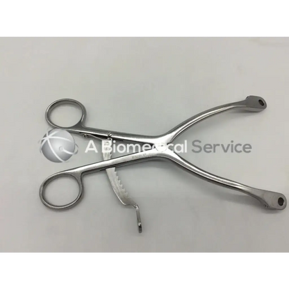 Stainless steel kolbel retractor ring handle with circular grips and serrated jaws for precise surgical clamping