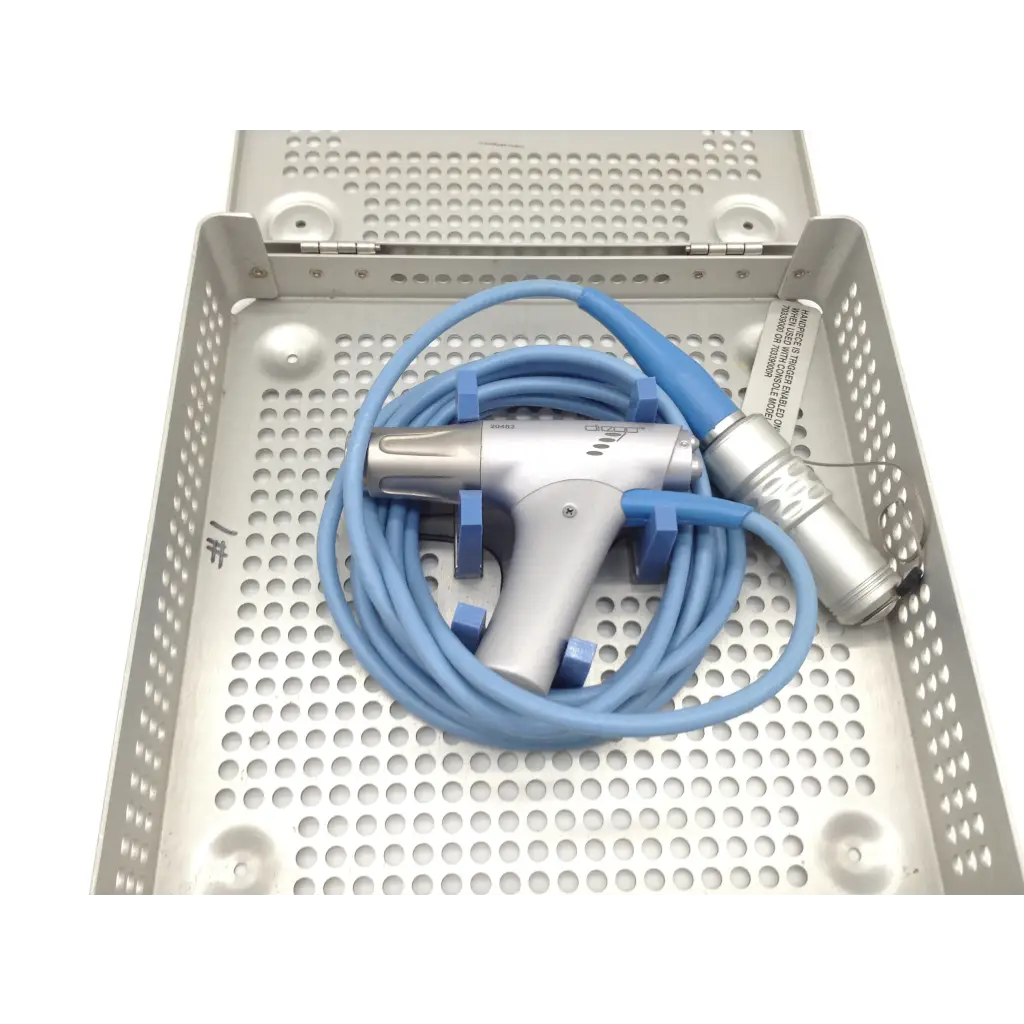 Silver and blue gyrus acmi diego shaver handpiece with coiled tubing resting in perforated metal tray case