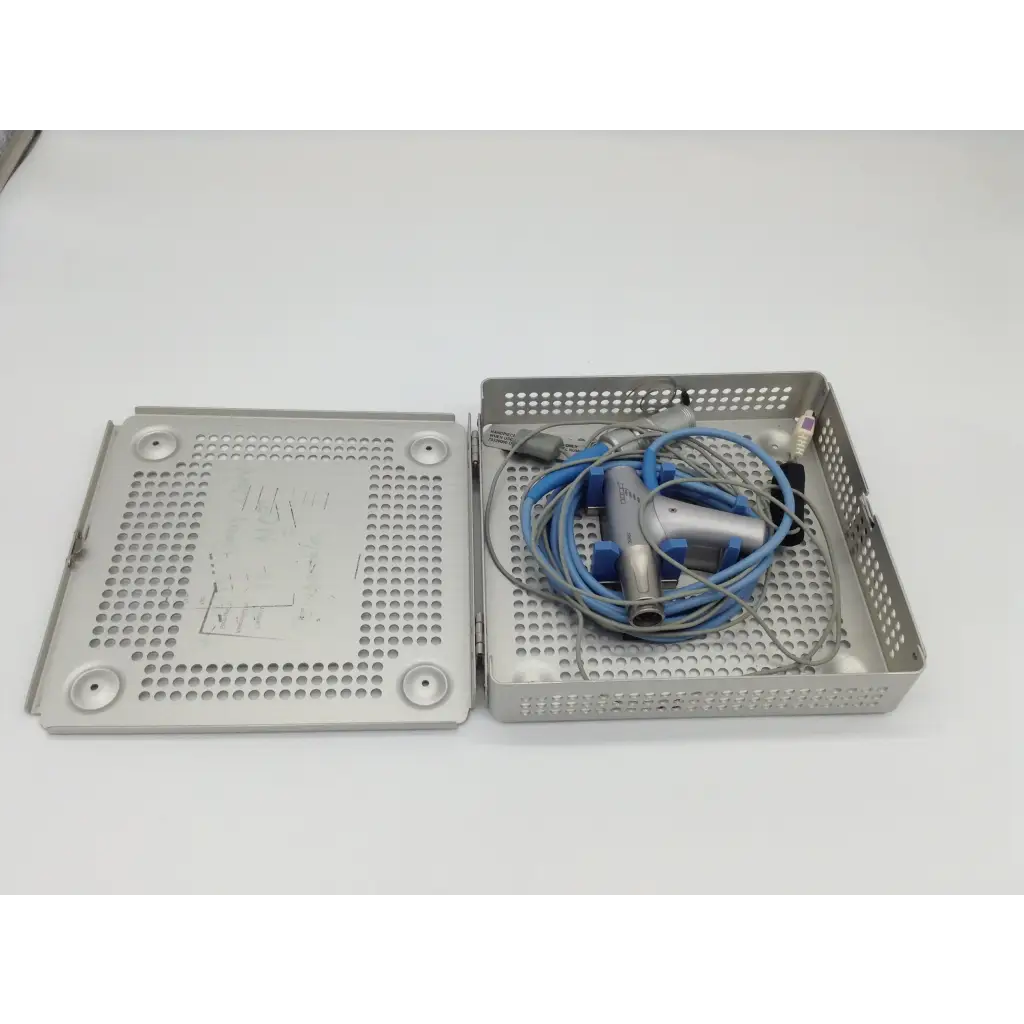 Silver perforated metal surgical tray holding a coiled blue and gray gyrus acmi diego shaver handpiece with case
