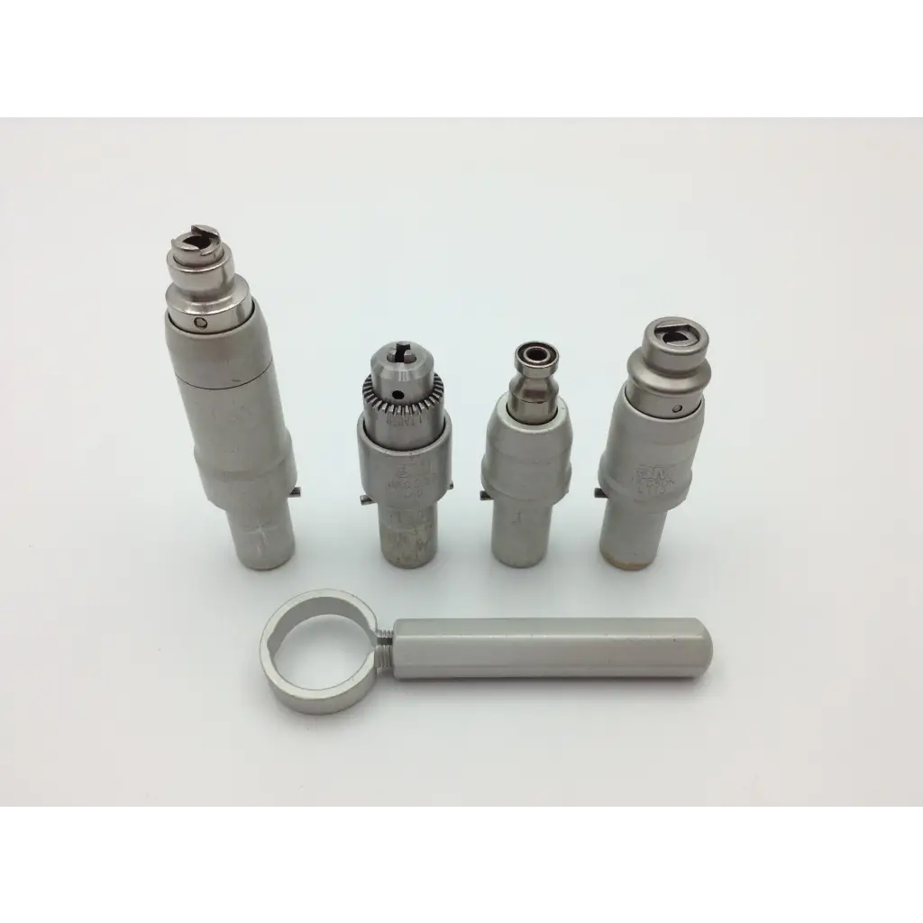 Set of four metallic dental handpieces with varying tips and matching handle in polished silver with a maxi-driver ii autoclave case