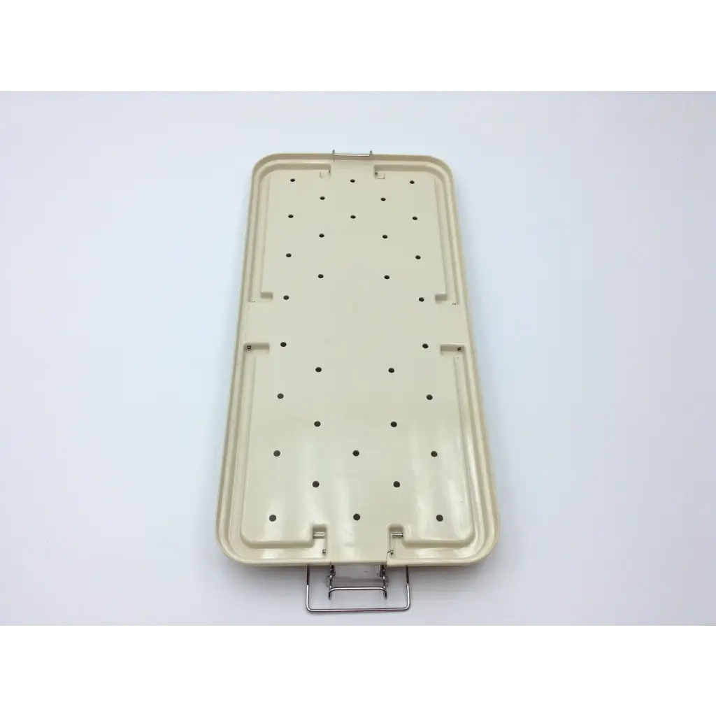 Beige plastic surgical instrument tray with metal handle and circular indentations in maxi-driver ii autoclave case