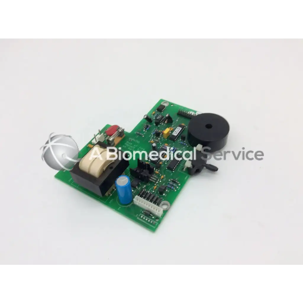Green printed circuit board power supply parts with black speaker blue capacitor beige transformer and silver component