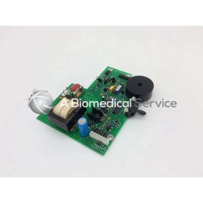 Green printed circuit board power supply parts with black speaker blue capacitor beige transformer and silver component