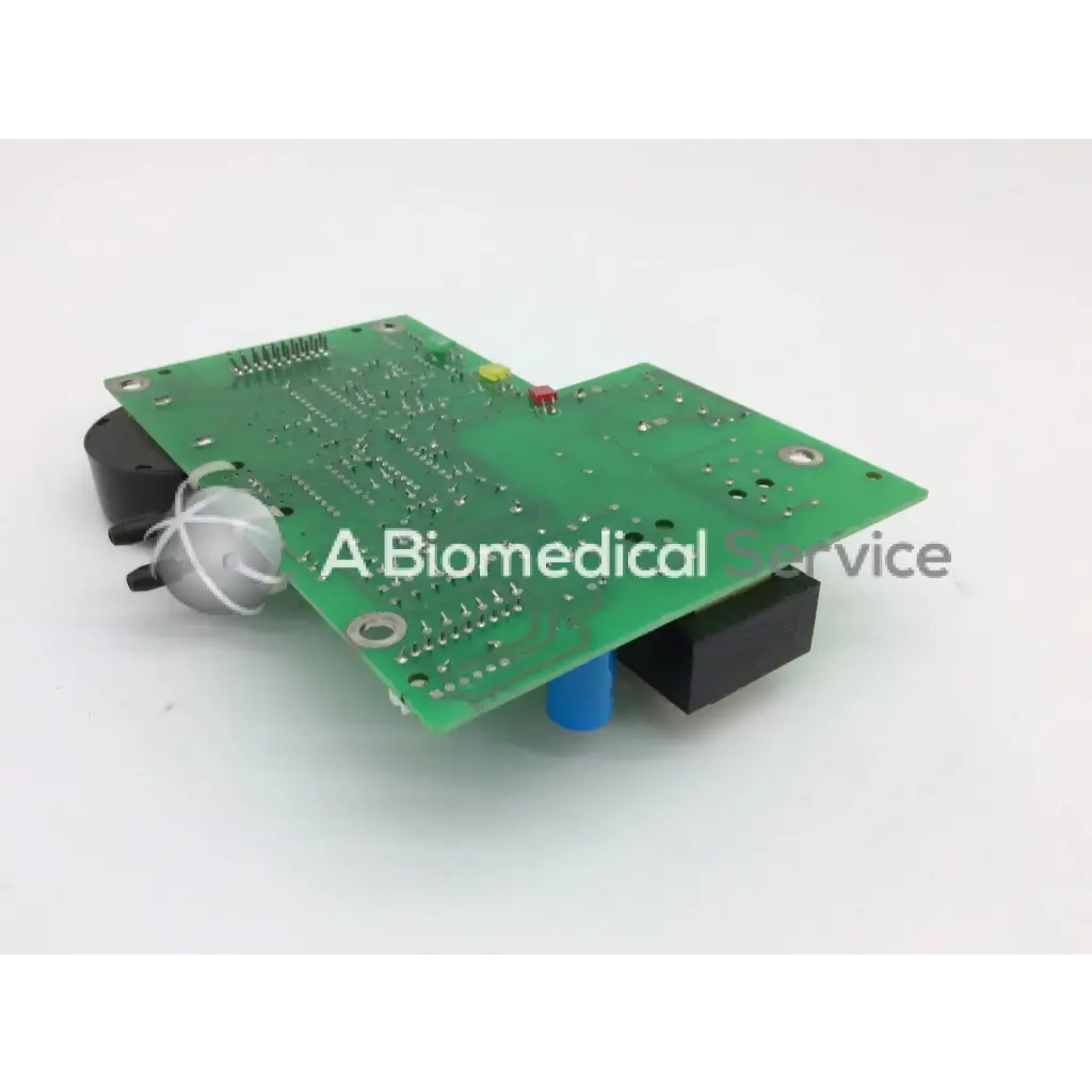Green printed circuit board power supply parts with black and blue connectors silver bulb and red yellow indicator lights
