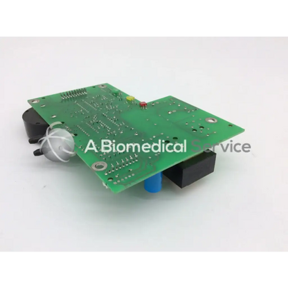 Green printed circuit board power supply parts with black and blue connectors silver bulb and red yellow indicator lights