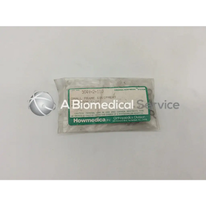 A clear plastic bag of small metallic howmedica orthopedic fixation stop clips labeled stop clip 5mm in green and white
