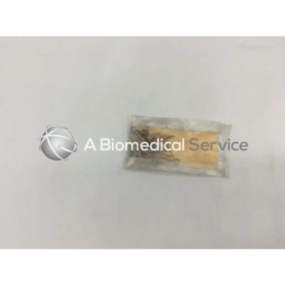 A clear plastic bag containing howmedica orthopedic fixation stop clip 5mm metal surgical clips with yellow insert