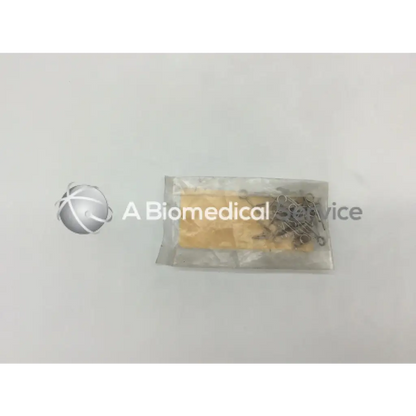 A clear plastic bag containing a yellow orthopedic fixation stop sponge and metallic howmedica fixation stop clip 5mm