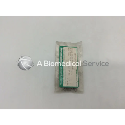 A package of small metallic orthopedic fixation stop clips 5mm from Howmedica with green and white label