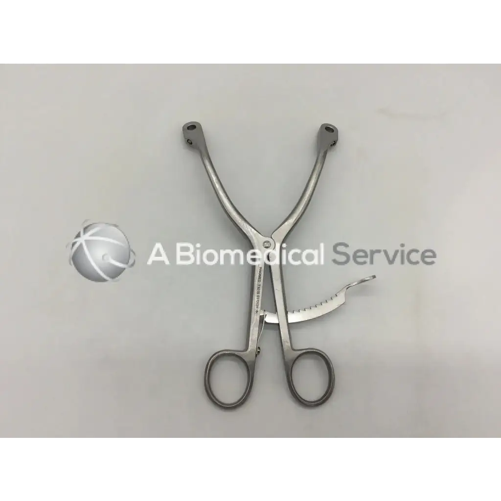 Silver innomed t1015 kolbel surgical instrument with curved handles and serrated cutting blade for precise surgery