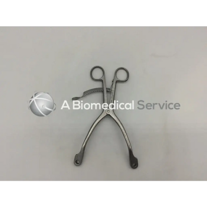 Innomed t1015 kolbel stainless steel surgical clamp with curved handles and serrated jaw for precise grip