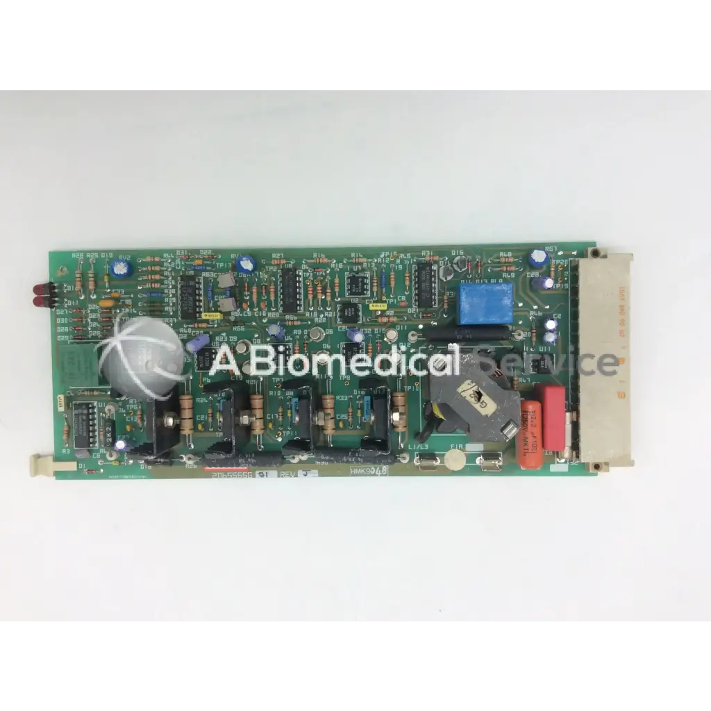 Green rectangular circuit board with capacitors and integrated circuits instem 2065555g rev j hmk9048 board
