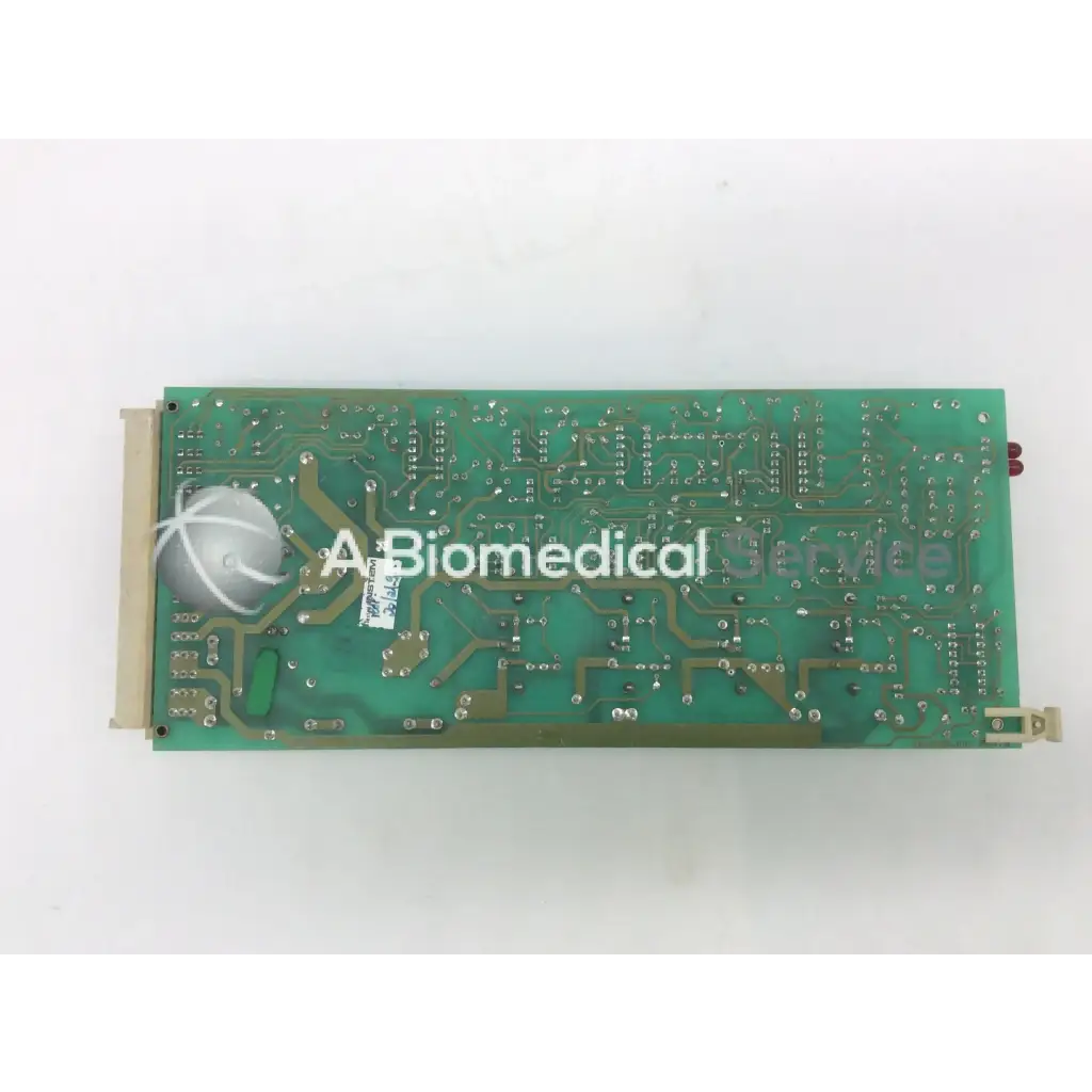 Green rectangular instem 2065555g rev j hmk9048 board with silver soldered components and white circular connector on left side