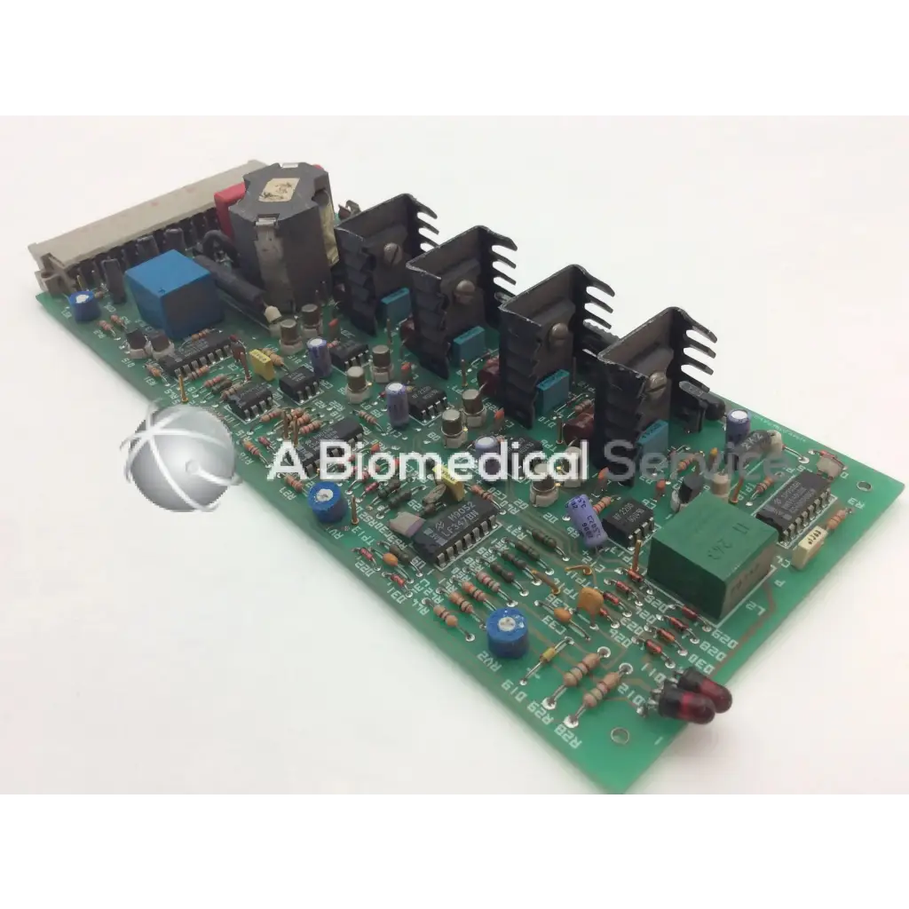 Green printed circuit board with black heat sinks blue capacitors and components instem 2065555g rev l hmk9048 board