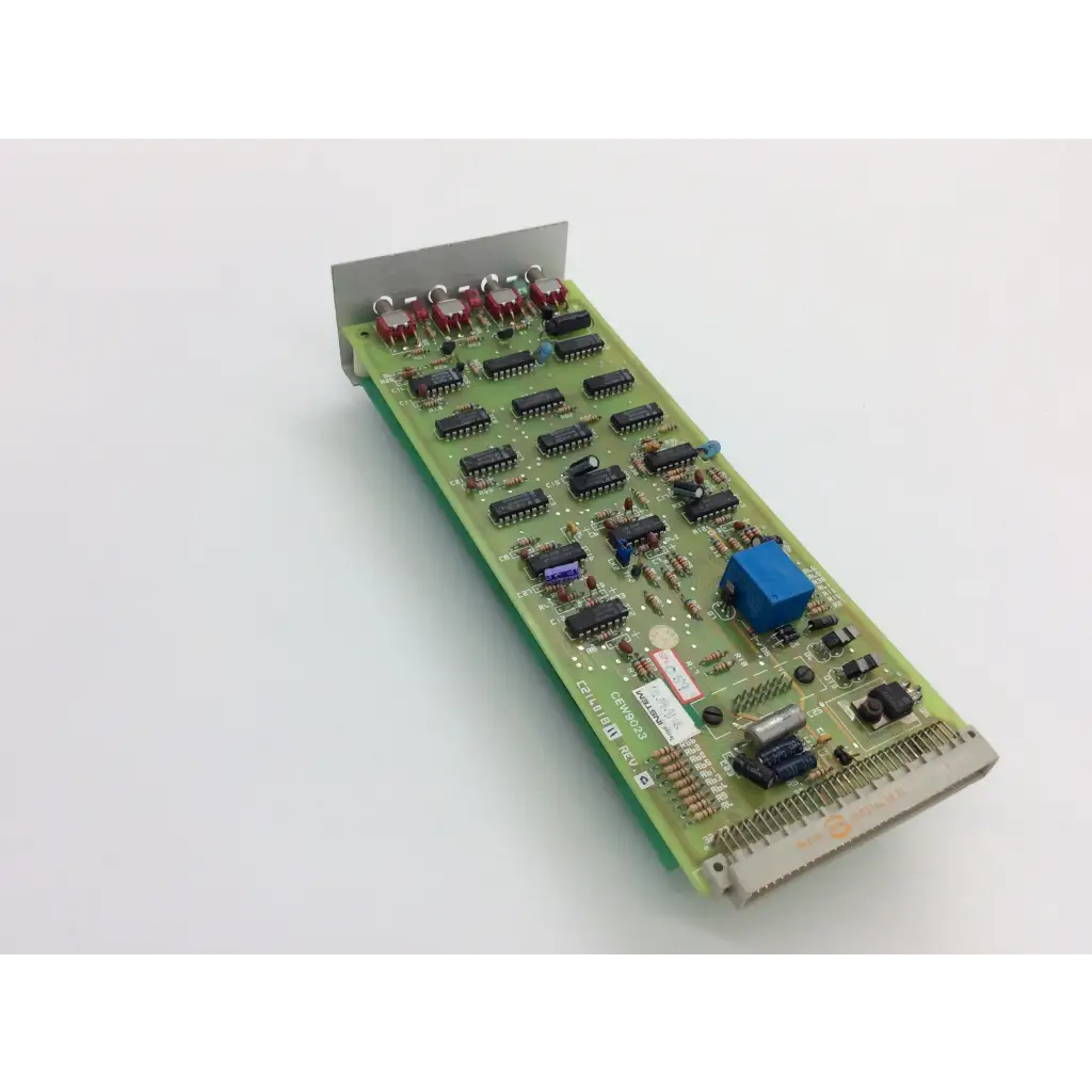 Green printed circuit board with black integrated circuits red capacitors and blue component instem c21401811 rev c cew9023 c214020 rev d