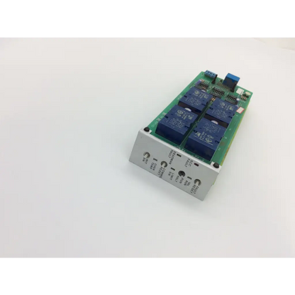 Green circuit board instem c21401811 rev with four blue relay modules and labeled screw terminals on silver metal panel