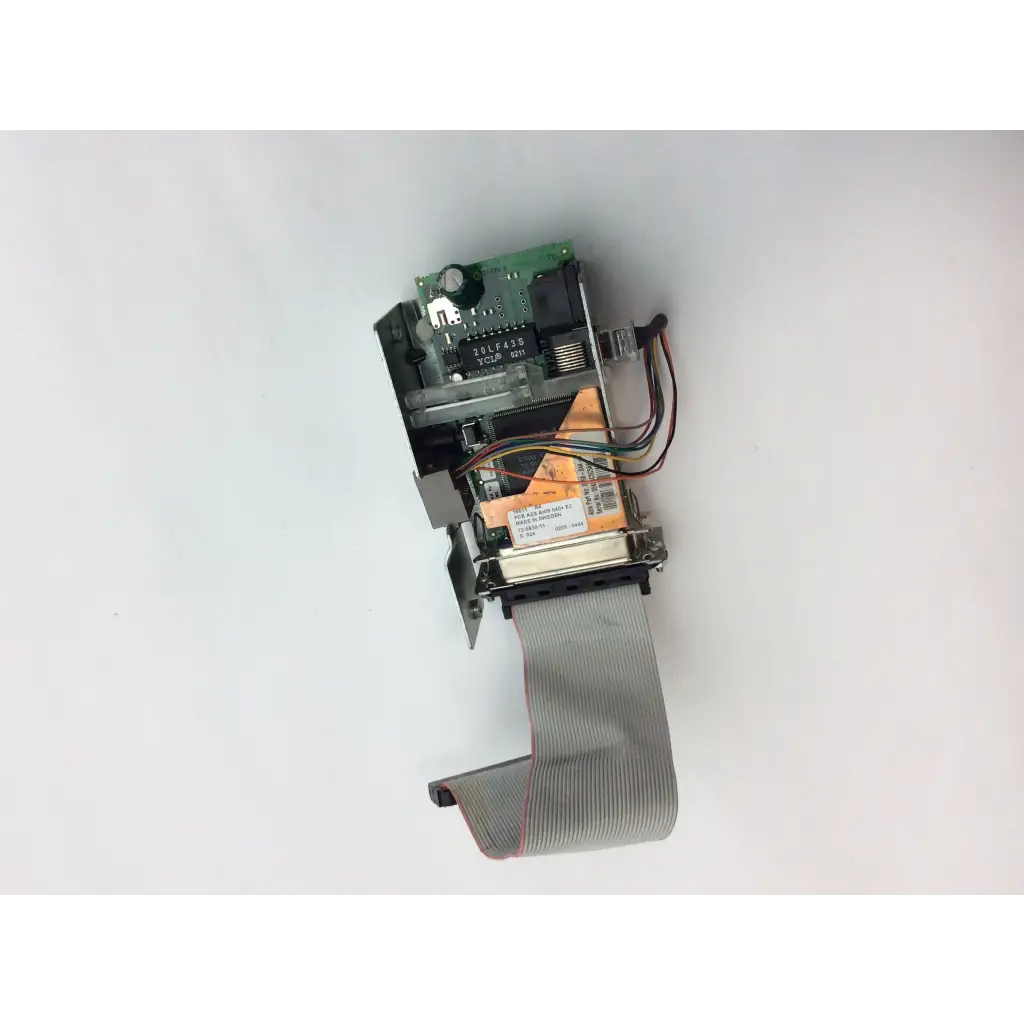 Gray ribbon cable extends from a green intermec 068832-001 3400e thermal label printer ethernet interface board