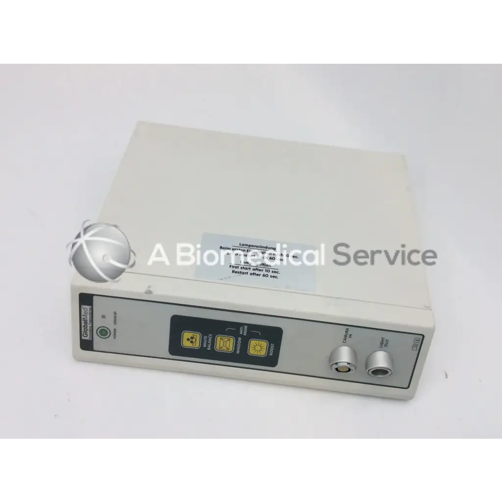 Beige rectangular jedmed globalmed xe30 medical light source with control panel, yellow warning symbols, and two silver knobs